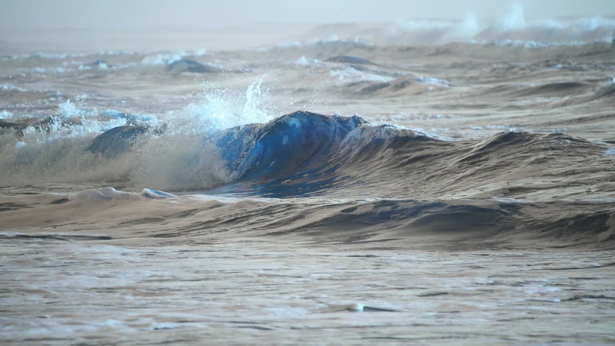 Captivating scene of ocean waves crashing under the soft morning light, highlighting nature's power.